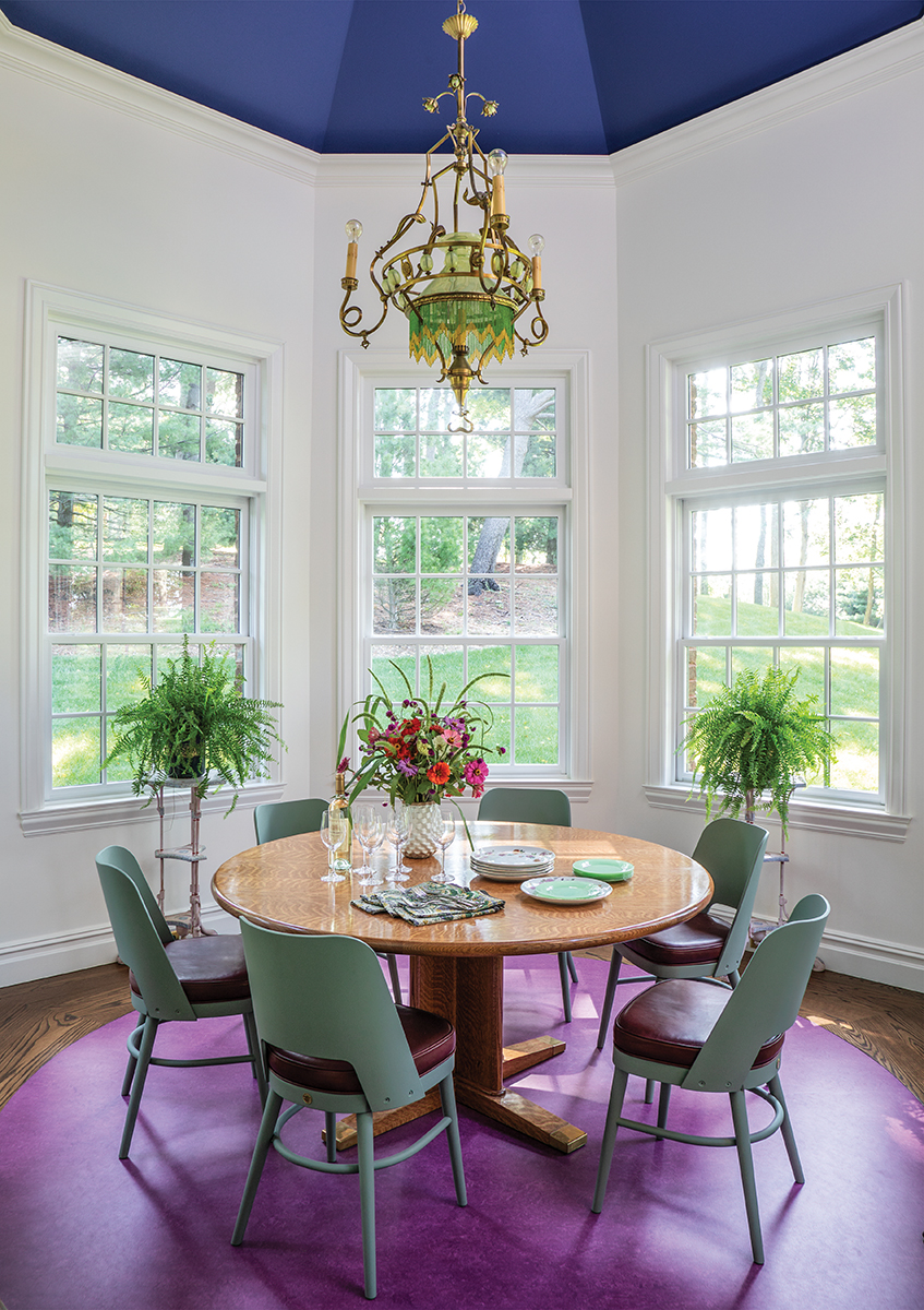 Dining space with purple floor in bay window.