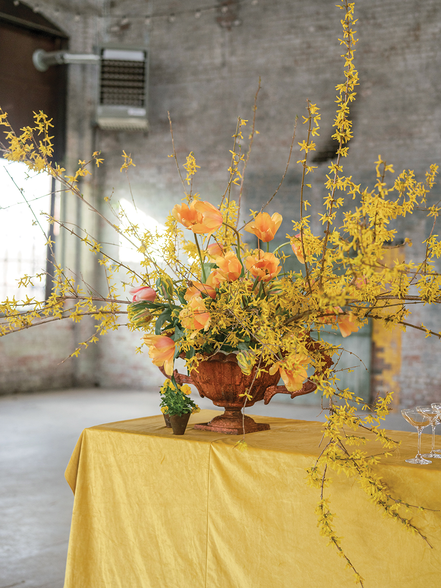 Large centerpiece arrangement of forsythia and other yellow flowers
