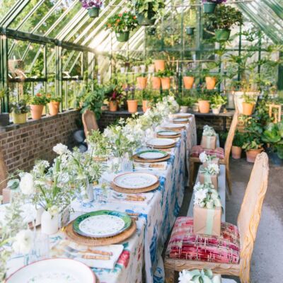 Table in greenhouse set for a Sister Parish party