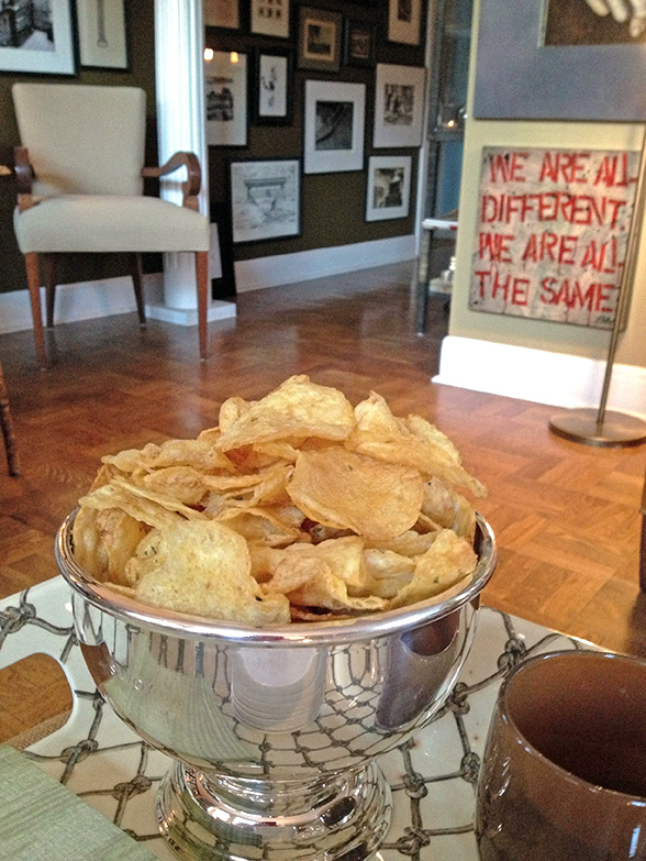 Large silver bowl filled with potato chips, a classic no-cook cocktail nibble