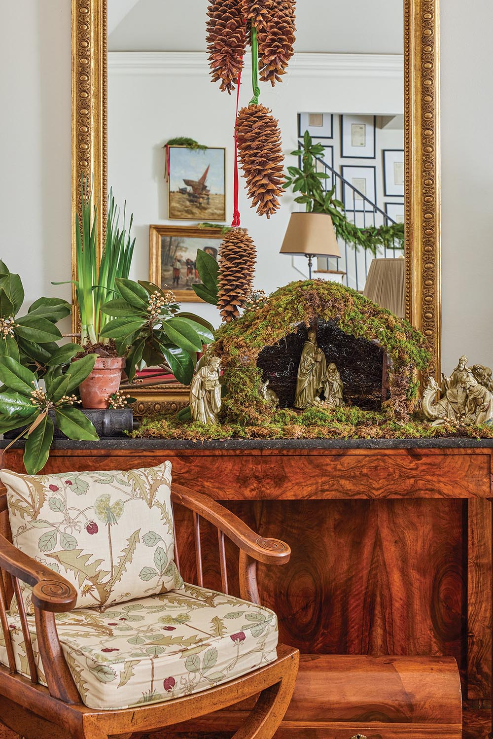 sideboard decorated with pine cones, magnolia leaves and paperwhites