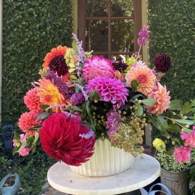 Lewis Miller arrangement of dahlias and foraged camellias, beautyberry, and Russian sage.