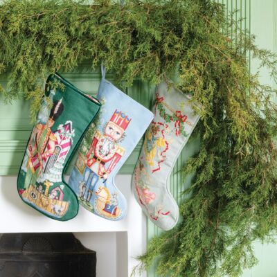 Stockings hung on mantel with evergreen garland at Brooke's Bank