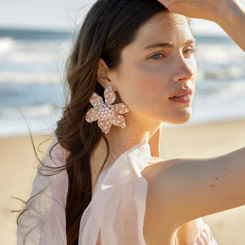 Model wearing camellia pearl statement earrings