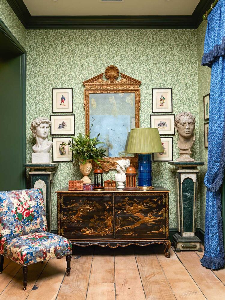 Second-floor landing with antique chair, busts, Chinoiserie cabinet