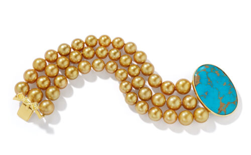 Triple strand of gold pearls with turquoise stone.