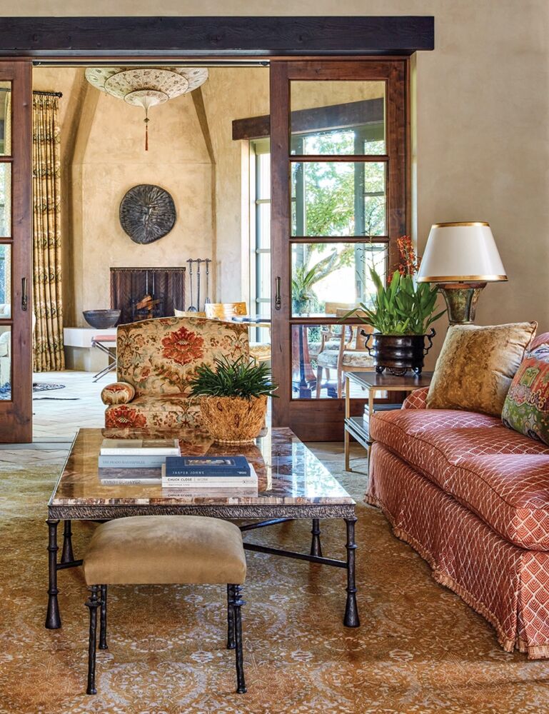 Living room of Napa Valley home with fireplace and doors open to outside views.