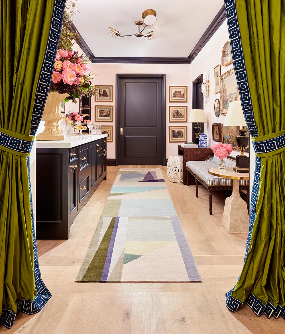 Green portieres with blue Greek key trim frame view into hallway with morning bar designed by Corey Damen Jenkins.