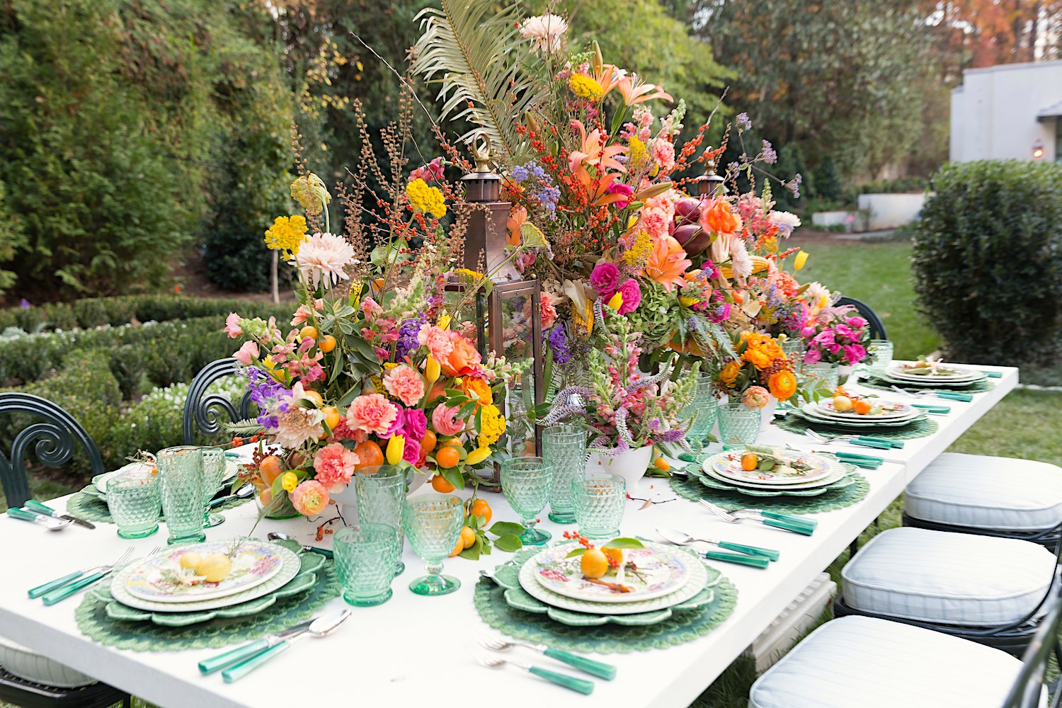 Elaine Griffin tablescape in backyard with Canaan Marshall centerpiece of flower arrangements.