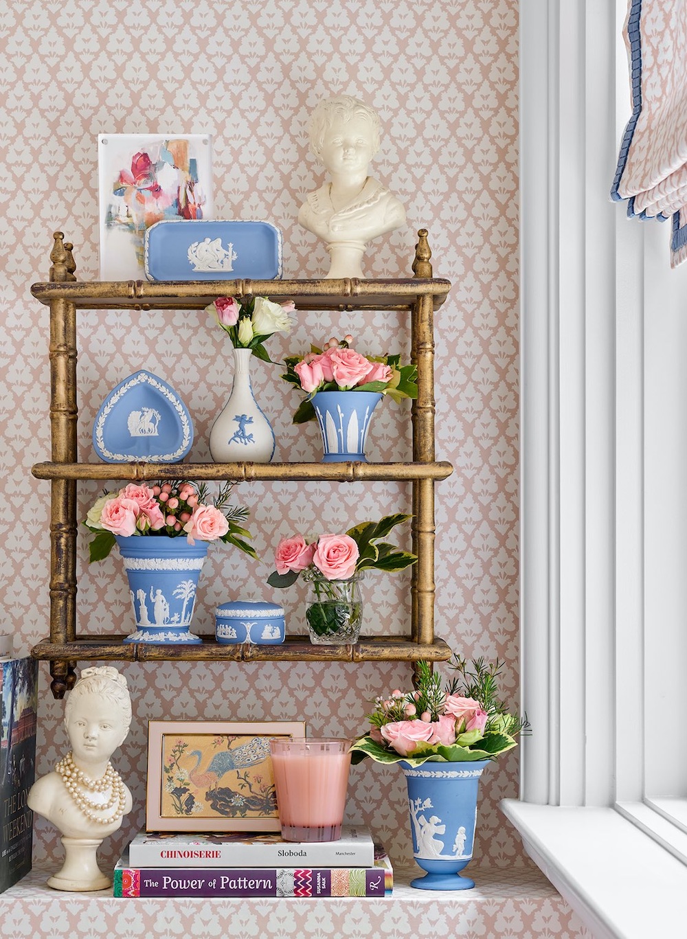 Shelf with blue jasperware and pink rose arrangements in bathroom of Mallory Mathison designed space.