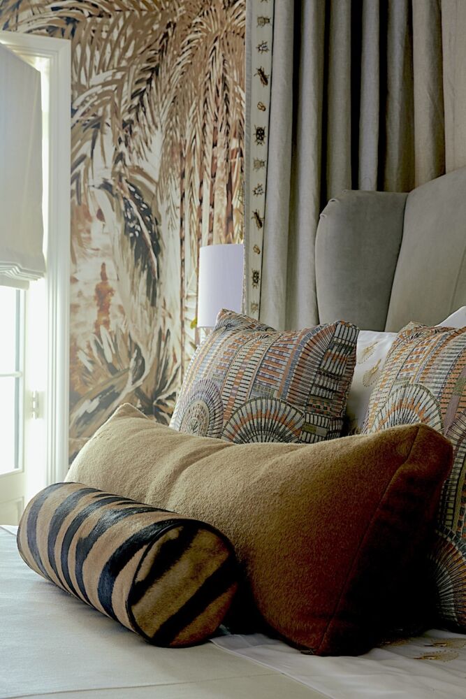 Zebra-striped bolster and other pillows on bed in the terrace-level guest bedroom at the Flower Atlanta Showhouse