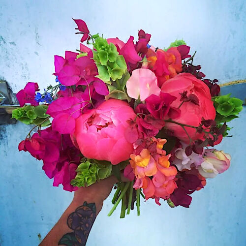 Wedding bouquet with peonies, snapdragons, bells of Ireland, and bougainvillea
