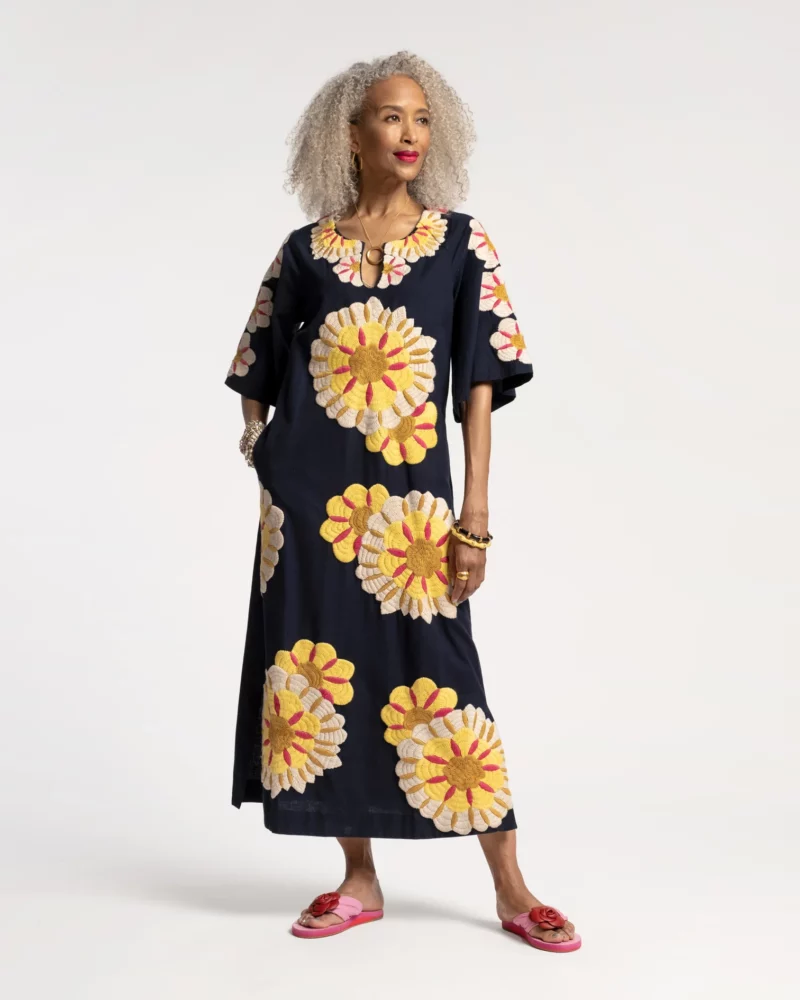 An oversized navy caftan with large yellow embroidered flowers from Frances Valentine.