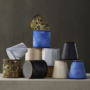 Marbleized paper lamp shades in tapered and drum shapes.