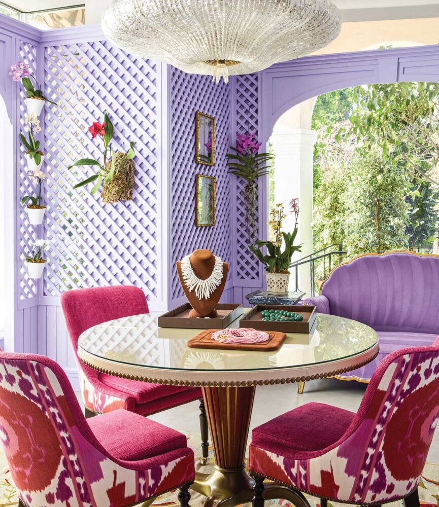 Magenta chairs around a table in Mish Tworkowski's lavender Palm Beach showroom.