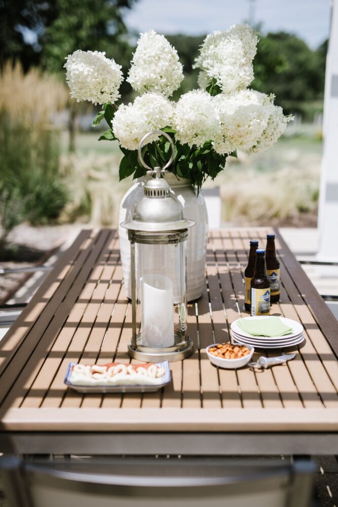 Large white cone hydrangeas dominate an outdoor table