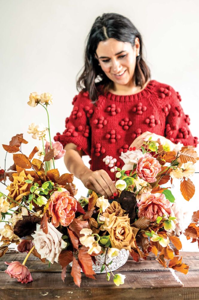 Maria Maxit finishes her floral arrangement.