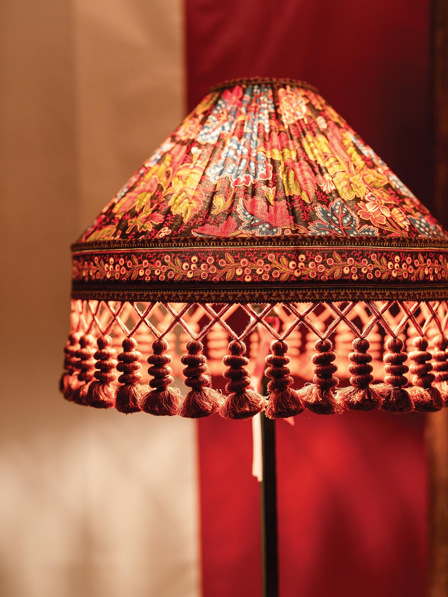 A soft glow comes from a floral patterned lampshade.