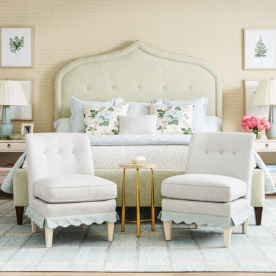 Bedroom with upholstered bed and pair of slipper chairs from Nellie Howard Ossi.