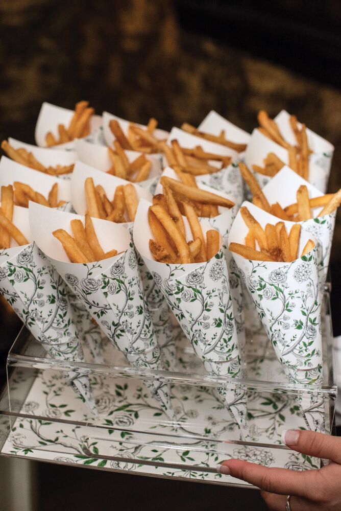 Fries are laid in a floral paper cone.