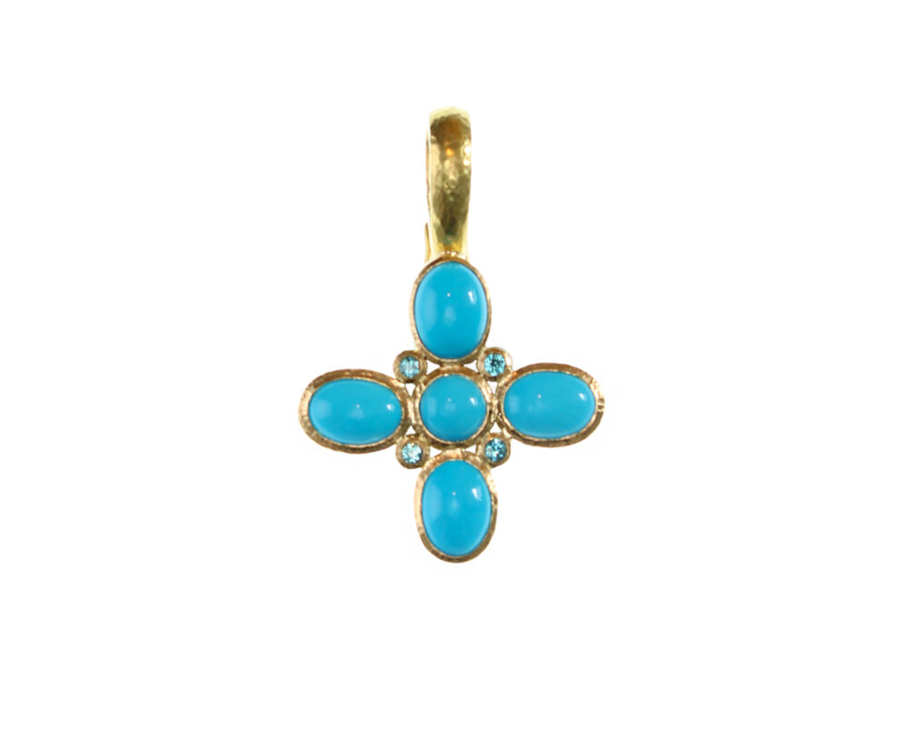 Turquoise jewels create a cross shape inside a gold pendant.