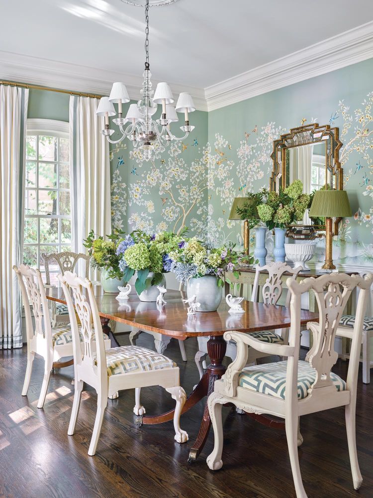 Floral wallpaper hangs in a bright dining room filled with hydrangeas.