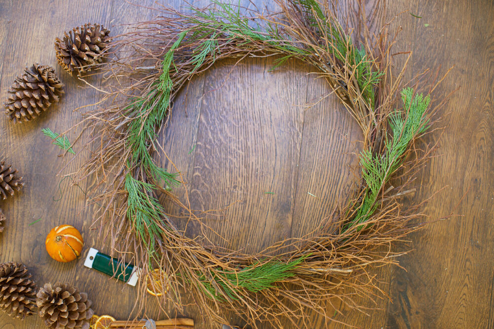 Green needles put in twig wreath.