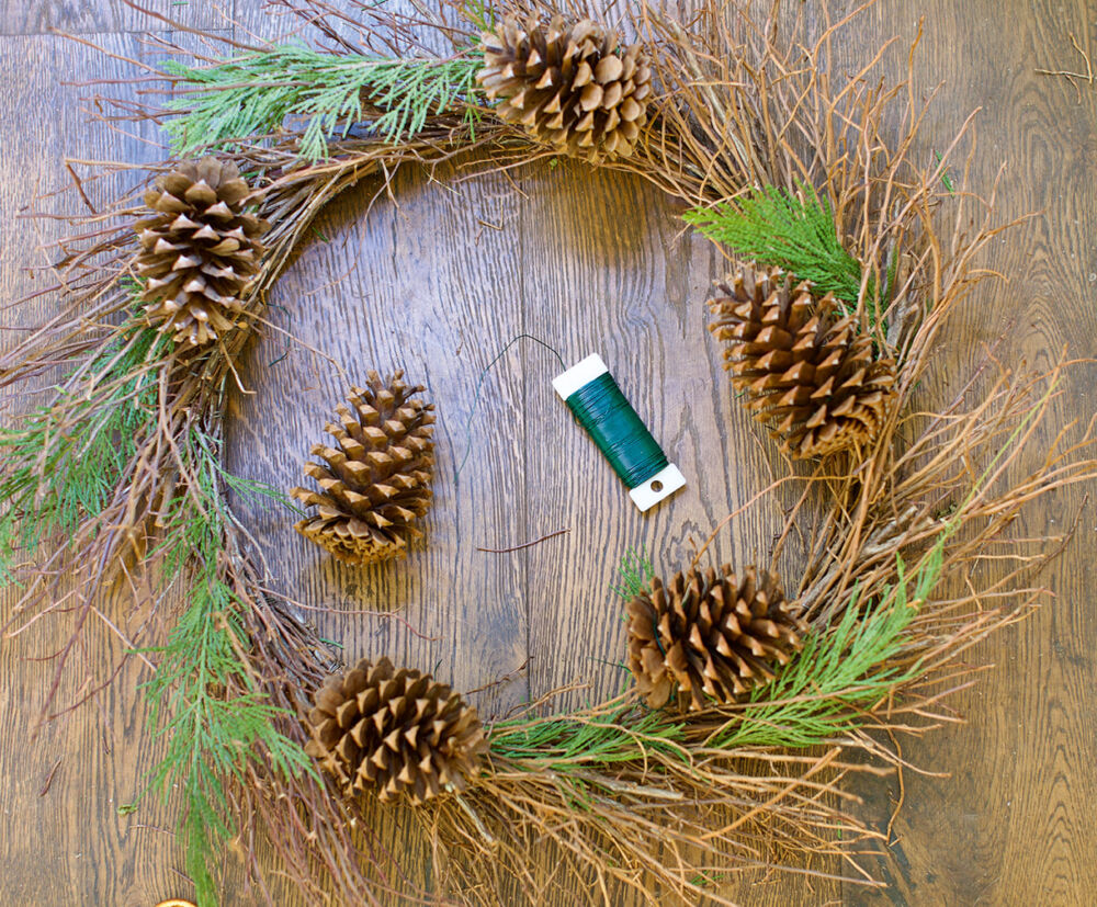 Wired is used to wrap pinecones on a Christmas wreath.