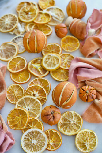 Dried and scored oranges lay on a countertop.