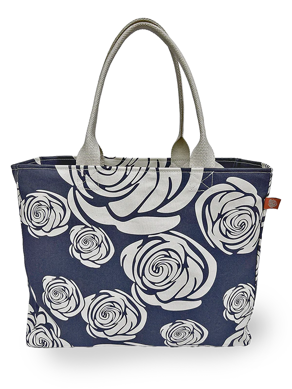 A navy canvas tote has white printed roses on it.