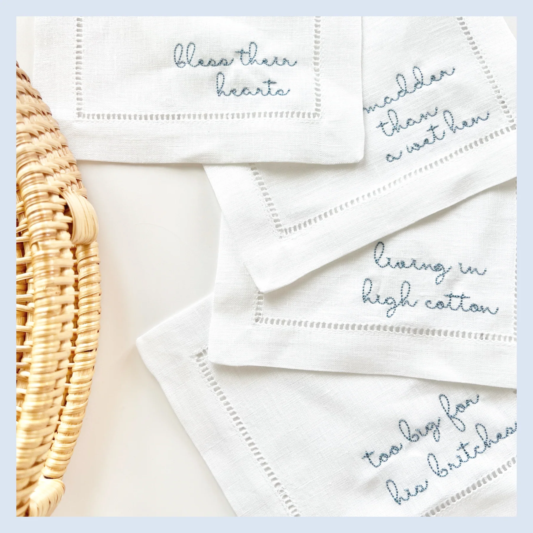 Four cocktail napkins have sassy southern sayings embroidered on them.