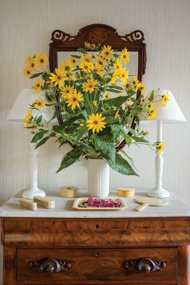 An antique marble-topped bedroom dresser with an arrangement of Black-eyed Susans fresh from the garden.