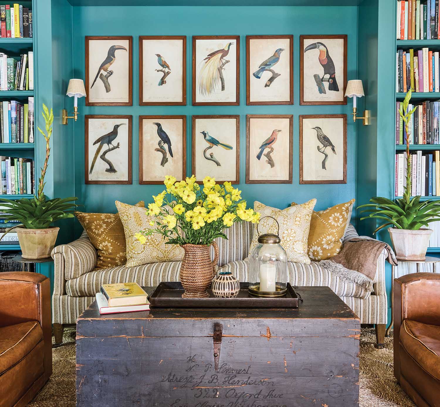 Bird prints cover a teal wall.