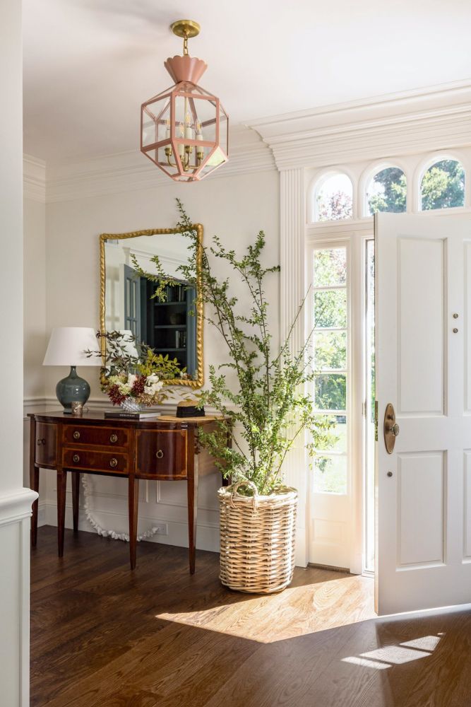 Branches light up an entryway basket.