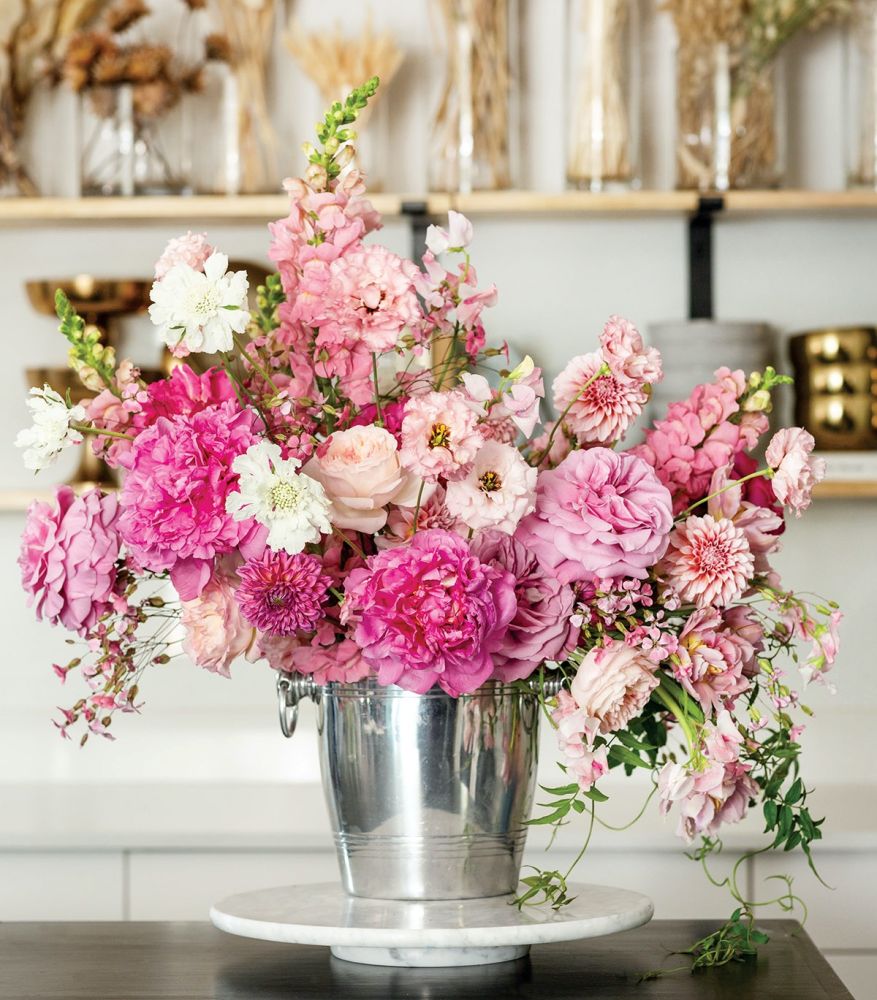 An arrangement of Snapdragons (Potomac pink), Jasmine vine, Garden roses, Peonies (Kansas pink), Double tulip (mauve pink), Dahlias Double lisianthus, and Scabiosa (white scoop).