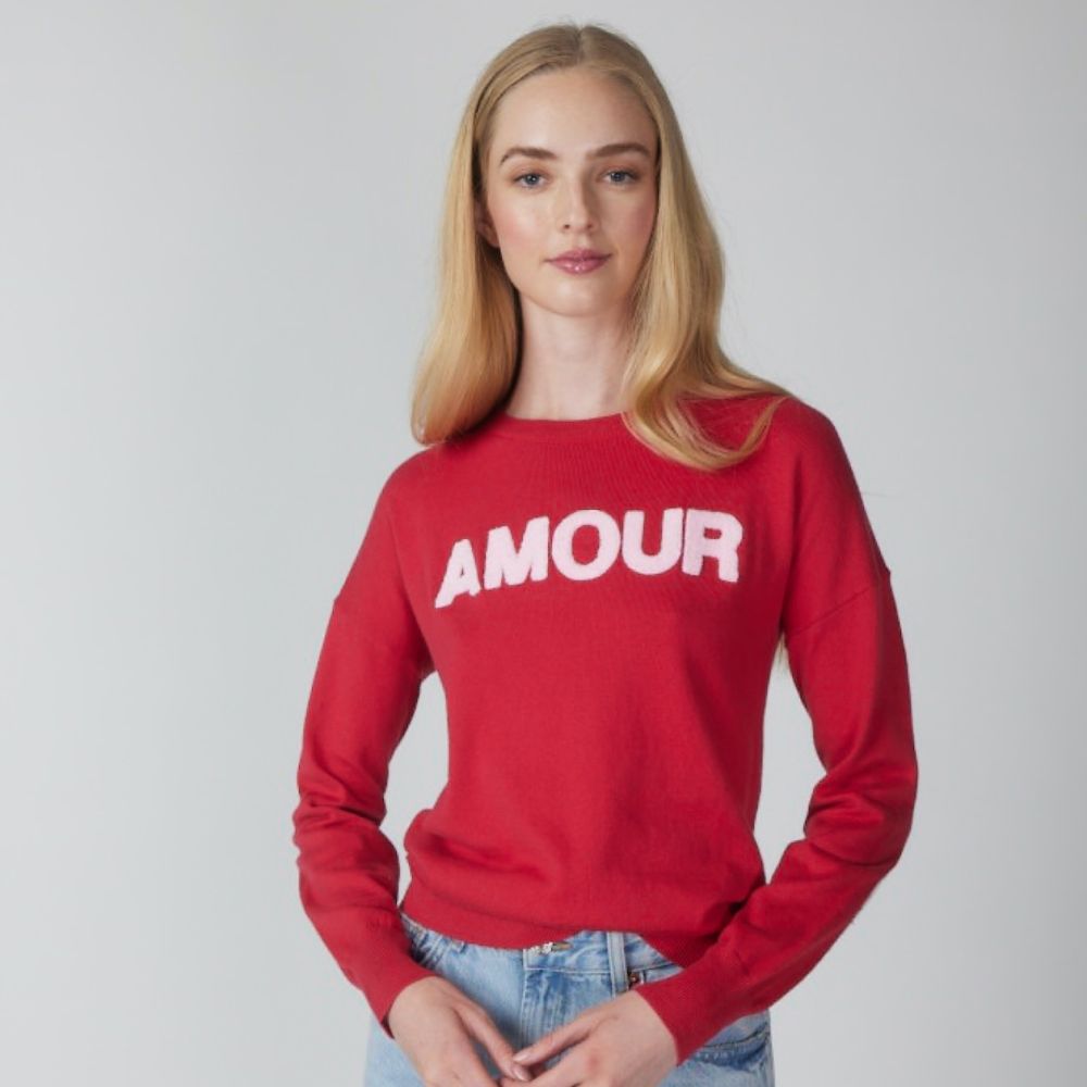 Woman with red sweater that says AMOUR.