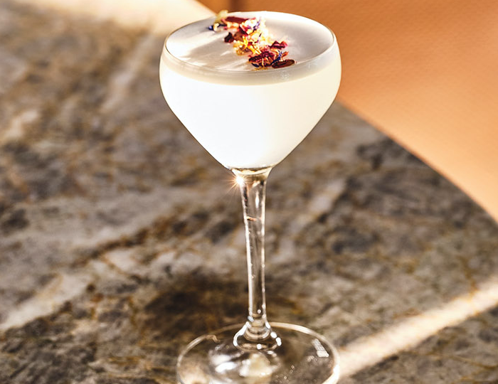 Fleur de Lis cocktail sits on a bar top.