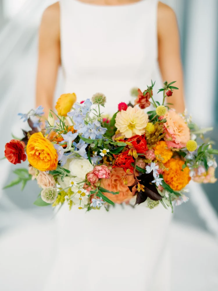 A colorful big bouquet held by a bride.