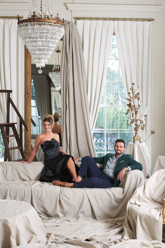 Jewel and Vincent Centanni sit on a cloth covered couch.