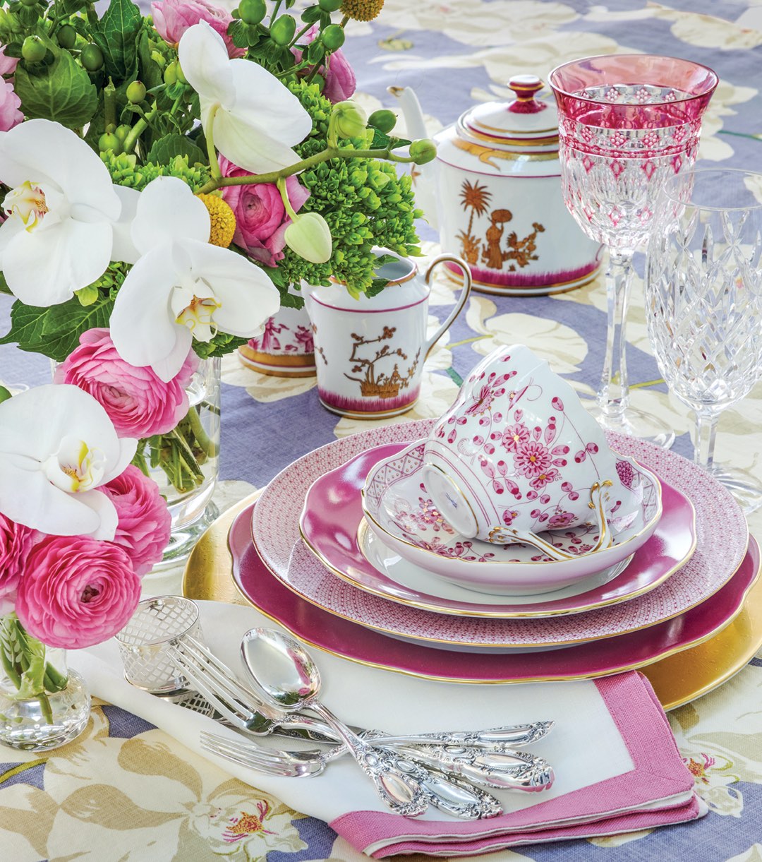 Tablescape with vivid pinks are balanced by crisp whites and cool blues