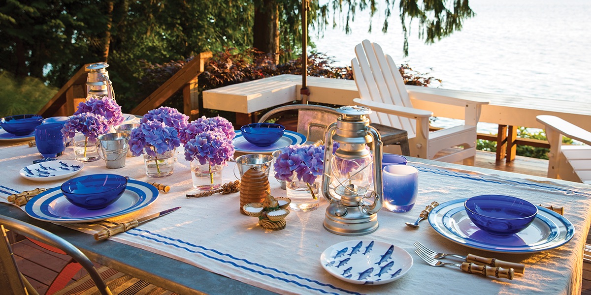 Summer dinner table with cobalt glassware and a mix of casual blue-and-white china.