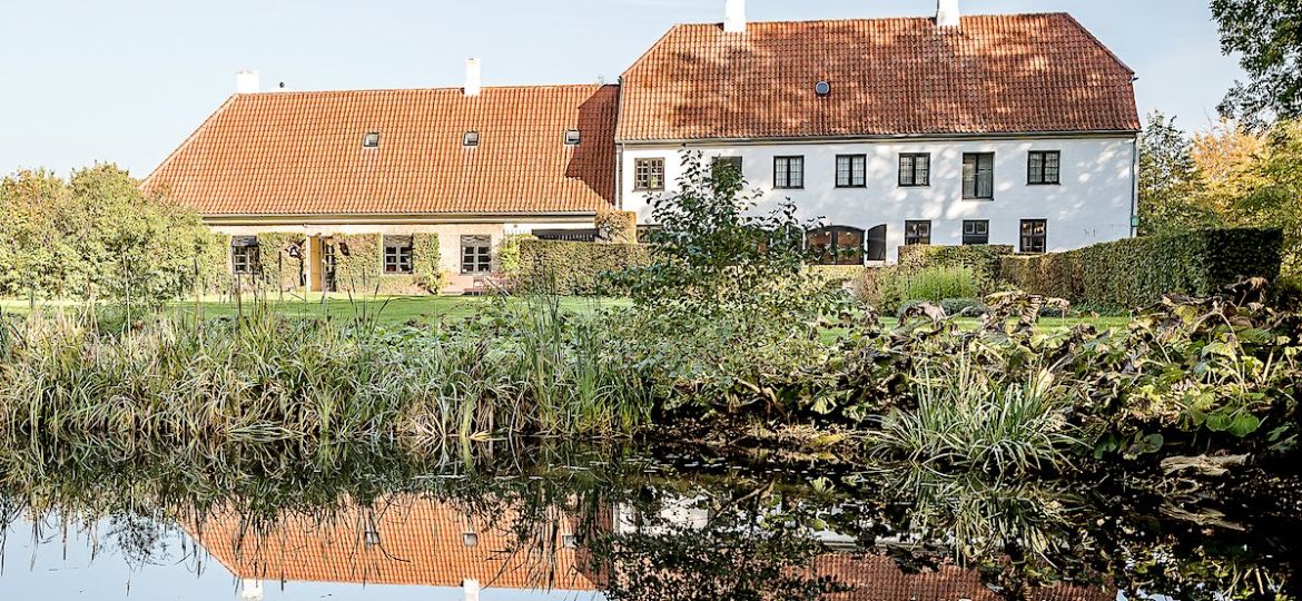Rungstedlund, the home of writer Karen Blixen, reflections in the garden pond, Rungsted, Denmark