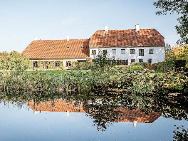 Rungstedlund, the home of writer Karen Blixen, reflections in the garden pond, Rungsted, Denmark