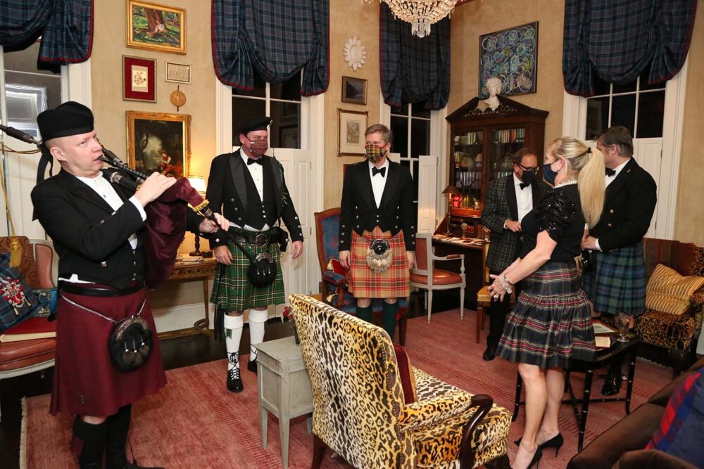 People in kilts at a dinner party.