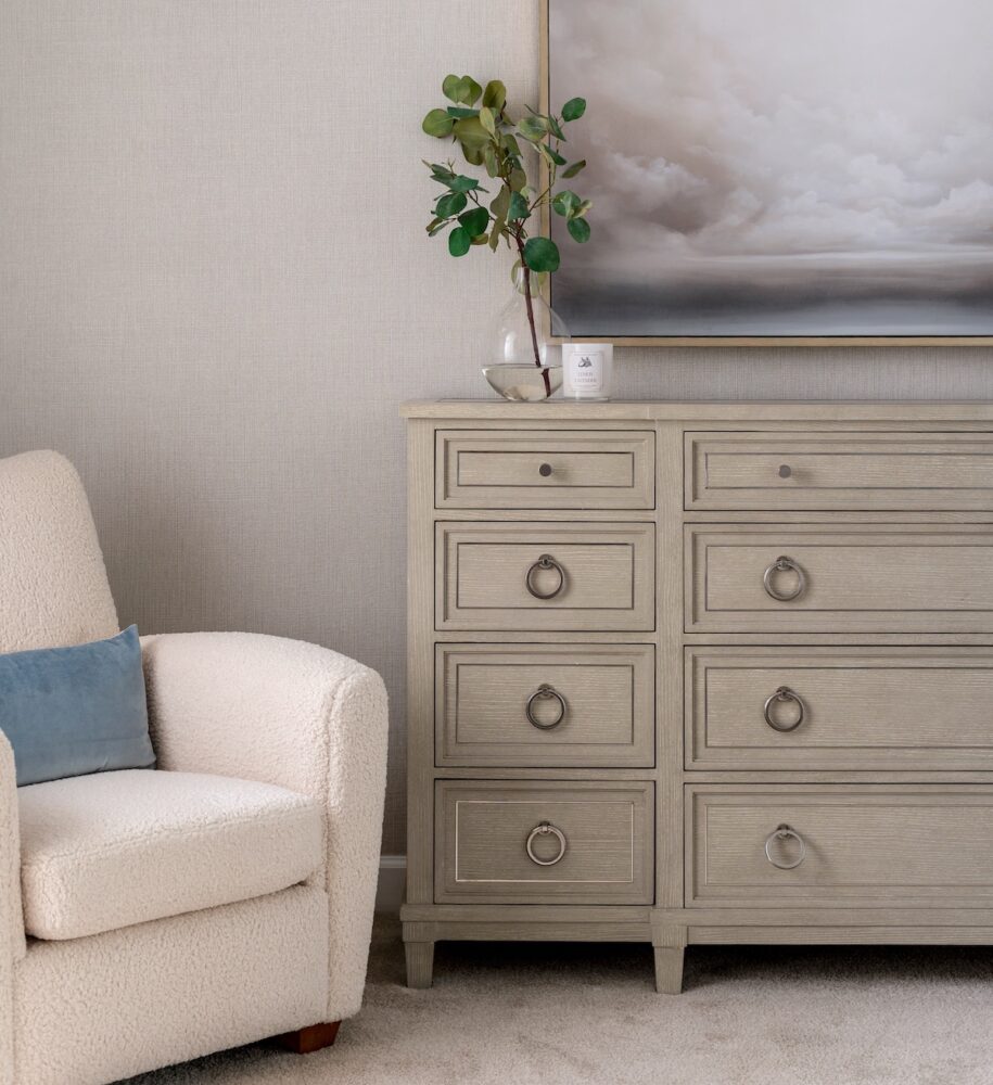 Pale-hued chest of drawers with small knobs and pull rings for hardware