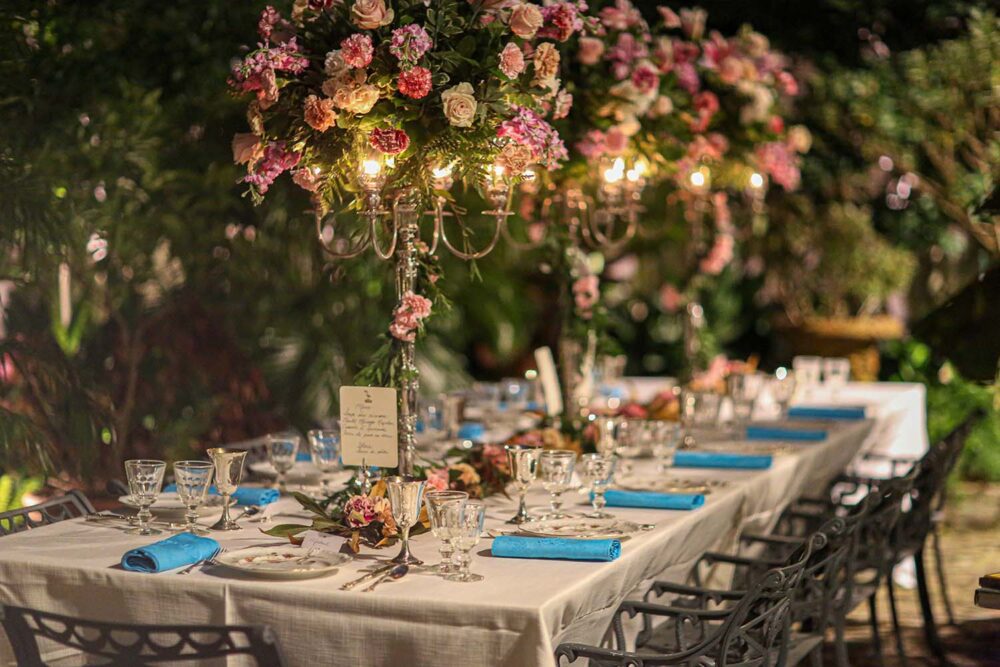 Tall arrangements of roses line a table.