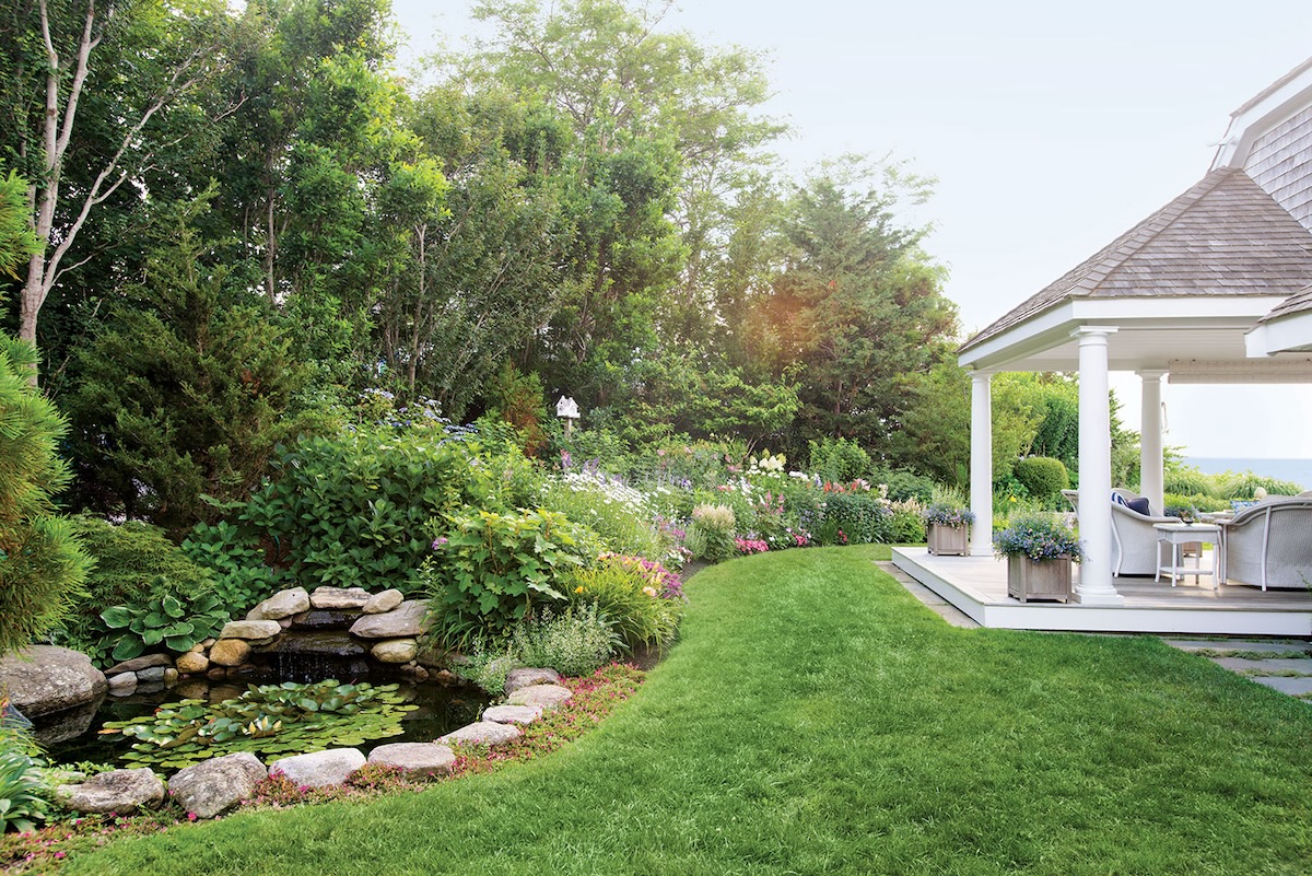 A porch, garden, and small pond are on the coastline of Nantucket.