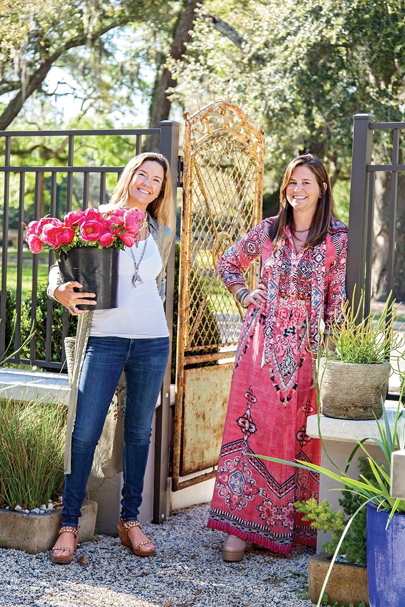Two women holding florals.