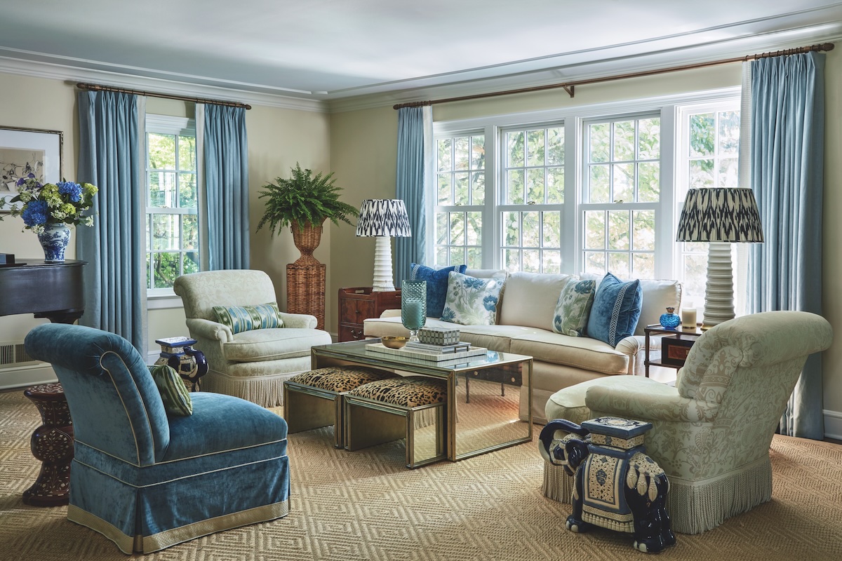 Living room painted in beige with blue accents.