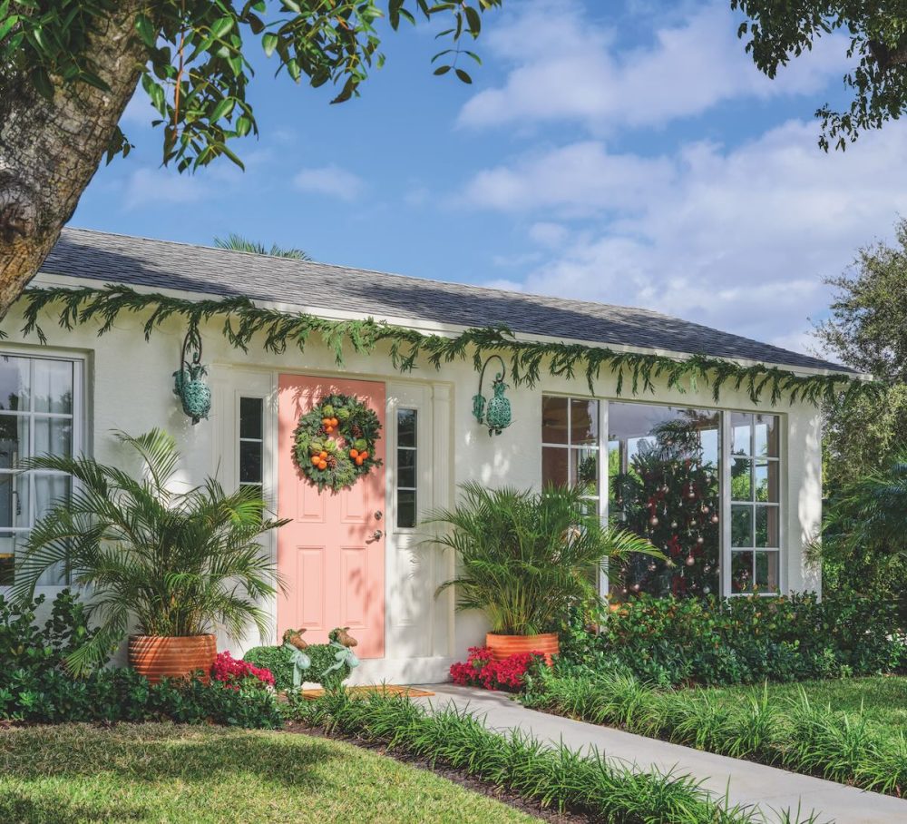 Outside of a pool house with a pink door.